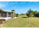 Large backyard with lush lawn and screened porch at 719 Winterbrooke Way, Sun City Center, FL 33573