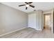 Spacious bedroom featuring a ceiling fan and mirrored closet doors at 719 Winterbrooke Way, Sun City Center, FL 33573