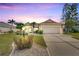 Inviting curb appeal with nicely landscaped yard and two-car garage at 719 Winterbrooke Way, Sun City Center, FL 33573