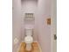 Small bathroom with toilet and wall-mounted shelving at 719 Winterbrooke Way, Sun City Center, FL 33573