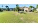 Large backyard with grassy area and partial view of home at 719 Winterbrooke Way, Sun City Center, FL 33573