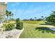 Spacious backyard with lush landscaping and view of neighboring homes at 719 Winterbrooke Way, Sun City Center, FL 33573