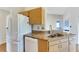 White fridge and granite countertops are featured here at 719 Winterbrooke Way, Sun City Center, FL 33573