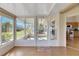 Sunroom with door access to the outdoors and view of the kitchen at 719 Winterbrooke Way, Sun City Center, FL 33573