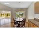Bright breakfast nook features a round table with chairs and view to a sunroom at 719 Winterbrooke Way, Sun City Center, FL 33573