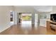 Spacious living area with hardwood floors and views to a sunroom at 719 Winterbrooke Way, Sun City Center, FL 33573