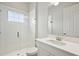 Bright bathroom featuring a glass door shower, a mirror, and a white vanity with modern fixtures at 13110 Homestead Ln, Parrish, FL 34219