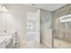 Bathroom vanity view with door open to bedroom and a glass enclosed shower at 13110 Homestead Ln, Parrish, FL 34219