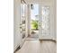 Elegant front door with decorative glass panel opens to a bright and inviting home at 13110 Homestead Ln, Parrish, FL 34219