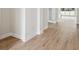 Hallway featuring beautiful wood-style flooring and neutral paint, leading to the main living area at 13110 Homestead Ln, Parrish, FL 34219