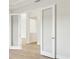 Bright interior view featuring glass doors, neutral walls, and laminated floors at 13110 Homestead Ln, Parrish, FL 34219