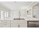 Open concept kitchen with stainless steel sink and views into the living room at 13110 Homestead Ln, Parrish, FL 34219