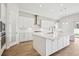Bright kitchen with stainless steel appliances, white cabinetry, and a large kitchen island at 13110 Homestead Ln, Parrish, FL 34219