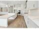 White kitchen boasts sleek cabinets, stainless steel appliances, and marble countertops at 13110 Homestead Ln, Parrish, FL 34219