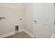 Bright laundry room featuring tiled floors and essential utility connections at 13110 Homestead Ln, Parrish, FL 34219