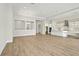 Open-concept living space with kitchen featuring white cabinetry, hardwood floors, and recessed lighting at 13110 Homestead Ln, Parrish, FL 34219
