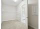 Bright walk-in closet featuring carpet, ample shelving, and convenient access to the bathroom at 13110 Homestead Ln, Parrish, FL 34219