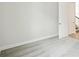Empty room with light-colored carpet, fresh white paint, and door leading to staircase at 13138 Homestead Ln, Parrish, FL 34219