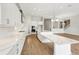 Bright kitchen featuring white cabinets, modern appliances, and large island with marble countertops at 13138 Homestead Ln, Parrish, FL 34219