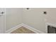 Bright laundry area showcasing updated electrical and plumbing components and wood-look vinyl flooring at 13138 Homestead Ln, Parrish, FL 34219