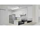 Bright kitchen with stainless steel appliances and white cabinets at 18001 Richmond Place Dr # 734, Tampa, FL 33647