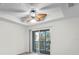 Main bedroom with balcony access, carpet flooring, and ceiling fan at 18001 Richmond Place Dr # 734, Tampa, FL 33647