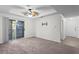 Bright living room with balcony access, carpet flooring and ceiling fan at 18001 Richmond Place Dr # 734, Tampa, FL 33647