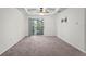 Bright living room with balcony access, carpet flooring and ceiling fan at 18001 Richmond Place Dr # 734, Tampa, FL 33647