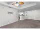 Living room with kitchen bar, carpet flooring and ceiling fan at 18001 Richmond Place Dr # 734, Tampa, FL 33647