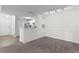 Spacious living room with carpet, kitchen bar, and access to the kitchen at 18001 Richmond Place Dr # 734, Tampa, FL 33647