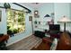 Home office with built-in shelving, large window, and comfortable seating at 3204 Stagecoach Trl, Wimauma, FL 33598