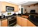Modern kitchen with stainless steel appliances and a corner sink at 3204 Stagecoach Trl, Wimauma, FL 33598
