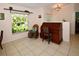 Bright office space with a wooden desk, rocking chair, and large window at 3204 Stagecoach Trl, Wimauma, FL 33598