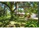Brick house with lush landscaping and large oak trees at 3204 Stagecoach Trl, Wimauma, FL 33598
