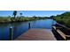 Wooden dock with bench overlooking waterway at 3204 Stagecoach Trl, Wimauma, FL 33598