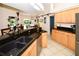 Eat-in kitchen with double sink, granite counters, and access to backyard at 3204 Stagecoach Trl, Wimauma, FL 33598