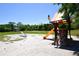 playground with slide and climbing wall at 3204 Stagecoach Trl, Wimauma, FL 33598