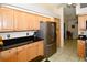 Bright kitchen featuring stainless steel appliances and light wood cabinets at 3204 Stagecoach Trl, Wimauma, FL 33598