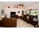 Relaxing living room featuring leather furniture and access to a screened patio at 3204 Stagecoach Trl, Wimauma, FL 33598