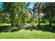 Landscaped garden with a stone path and bench at 3204 Stagecoach Trl, Wimauma, FL 33598