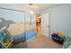 Bedroom with ocean mural, closet, and adjacent kitchen view at 3204 Stagecoach Trl, Wimauma, FL 33598