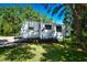 Enjoy this Jayco travel trailer, parked on a grassy lot with lush trees at 3204 Stagecoach Trl, Wimauma, FL 33598