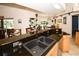 Kitchen features a double sink, granite countertops, and a view to the backyard at 3204 Stagecoach Trl, Wimauma, FL 33598