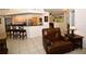 Bright, open living area with a kitchen, breakfast bar, and comfortable seating at 3204 Stagecoach Trl, Wimauma, FL 33598