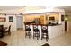 Kitchen with light wood cabinets, breakfast bar, and tile floor at 3204 Stagecoach Trl, Wimauma, FL 33598