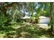 Brick ranch home with a two-car garage and nicely landscaped yard at 3204 Stagecoach Trl, Wimauma, FL 33598