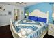 Bright bedroom with king bed, ensuite bath, and soothing blue walls at 3204 Stagecoach Trl, Wimauma, FL 33598