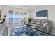 Living area with water views and a comfy grey couch at 4993 Bacopa S Ln # 705, St Petersburg, FL 33715