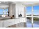 Bright kitchen with white cabinets, granite counters and water views at 4993 Bacopa S Ln # 705, St Petersburg, FL 33715