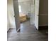 Bathroom with garden tub and gray wood-look floors at 11911 Rhodine Rd, Riverview, FL 33579